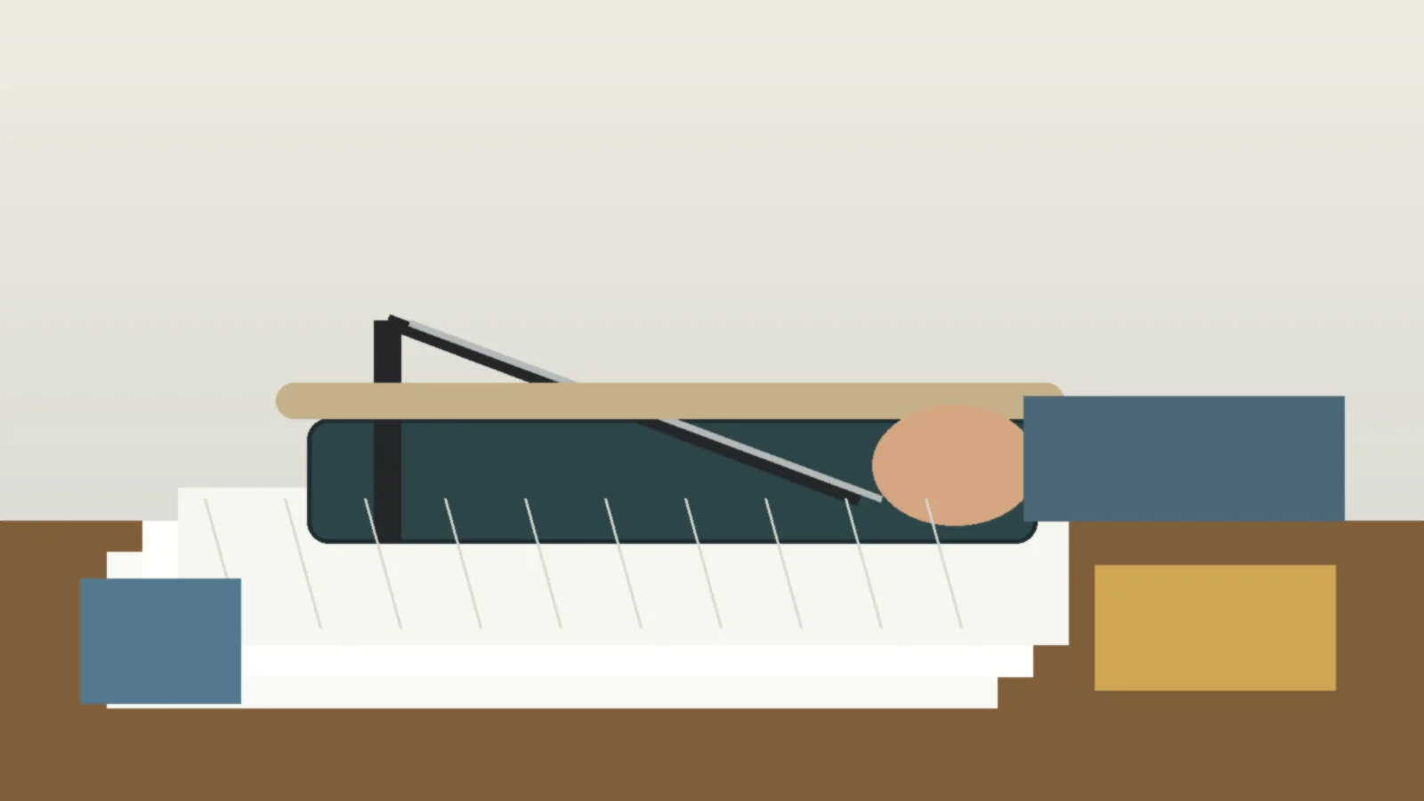 Person trimming paper with a guillotine paper cutter on a worktable